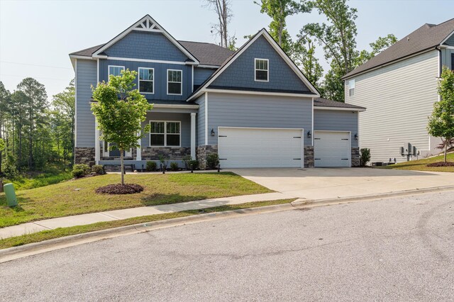 647 Bunchgrass St, Evans, GA 30809 - craftsman house featuring stone siding, an attached garage, concrete driveway, and a front yard