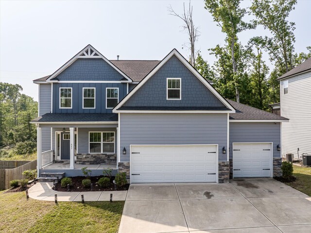 647 Bunchgrass St, Evans, GA 30809 - craftsman-style house featuring a porch, stone siding, driveway, an attached garage, and central AC