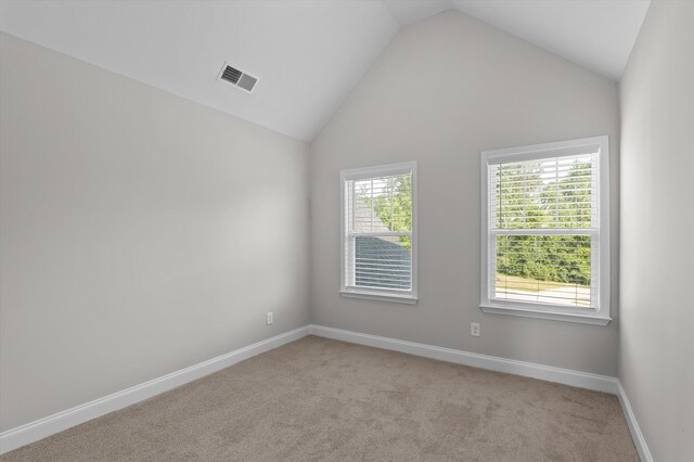 647 Bunchgrass St, Evans, GA 30809 - empty room featuring vaulted ceiling, light carpet, and baseboards