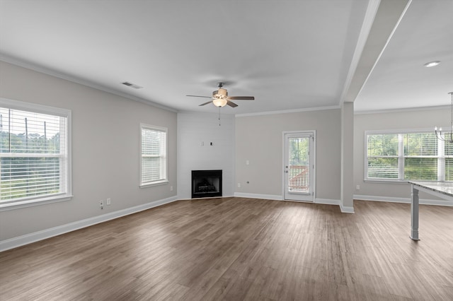 647 Bunchgrass St, Evans, GA 30809 - unfurnished living room featuring ceiling fan, wood finished floors, plenty of natural light, ornamental molding, and a large fireplace