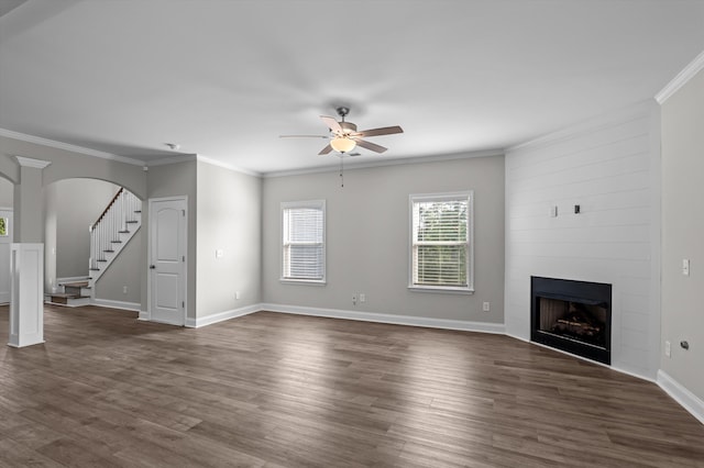 647 Bunchgrass St, Evans, GA 30809 - unfurnished living room with ceiling fan, a fireplace, stairs, ornamental molding, and arched walkways