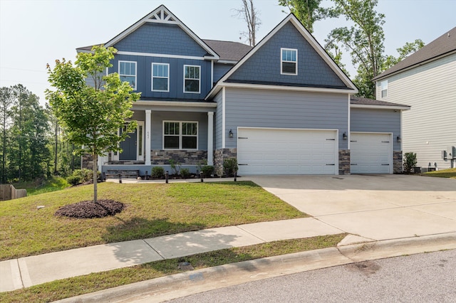 647 Bunchgrass St, Evans, GA 30809 - craftsman-style home featuring stone siding, a porch, concrete driveway, an attached garage, and a front yard
