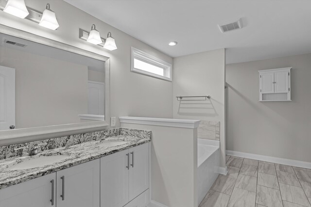 647 Bunchgrass St, Evans, GA 30809 - full bath featuring double vanity, a tub to relax in, marble finish flooring, baseboards, and recessed lighting