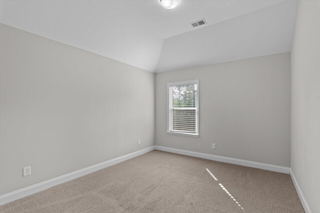 647 Bunchgrass St, Evans, GA 30809 - spare room with carpet floors, baseboards, and vaulted ceiling