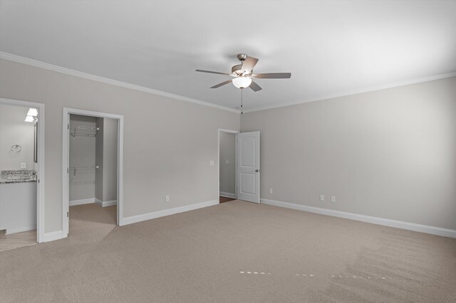 647 Bunchgrass St, Evans, GA 30809 - unfurnished bedroom featuring crown molding, a walk in closet, light carpet, a closet, and baseboards