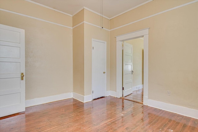 spare room featuring hardwood / wood-style floors and crown molding