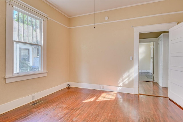 unfurnished room featuring crown molding and wood-type flooring