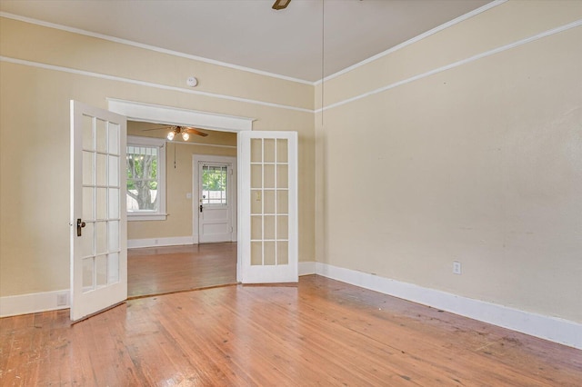 spare room with french doors, ornamental molding, and wood-type flooring