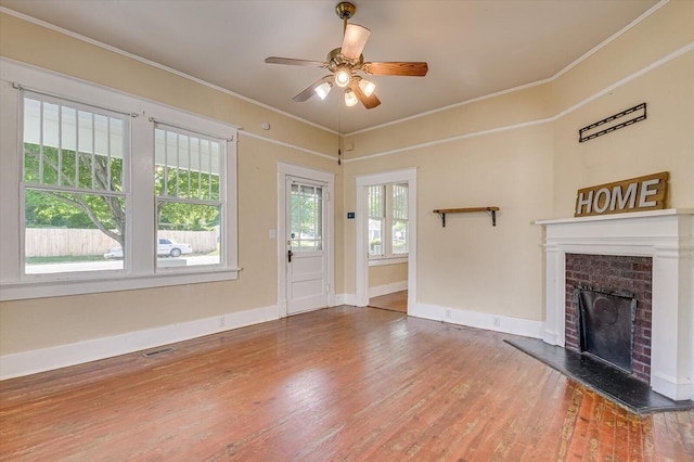 unfurnished living room with a fireplace, hardwood / wood-style floors, ceiling fan, and ornamental molding