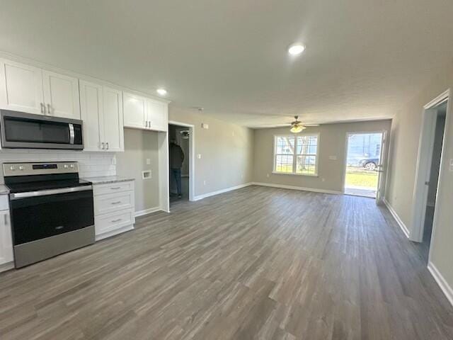 kitchen featuring white cabinets, ceiling fan, hardwood / wood-style flooring, and appliances with stainless steel finishes