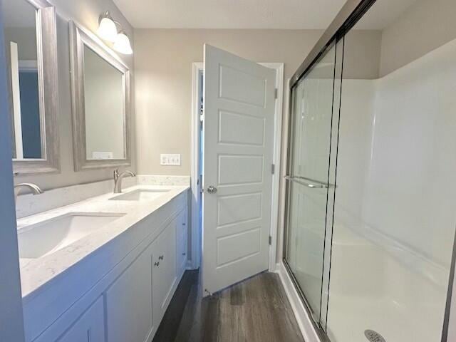 bathroom with vanity, wood-type flooring, and walk in shower