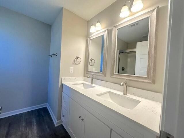 bathroom featuring hardwood / wood-style floors, vanity, and an enclosed shower