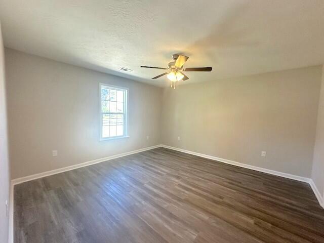111 Matthews St, Wrens, GA 30833 - spare room featuring dark wood finished floors and ceiling fan