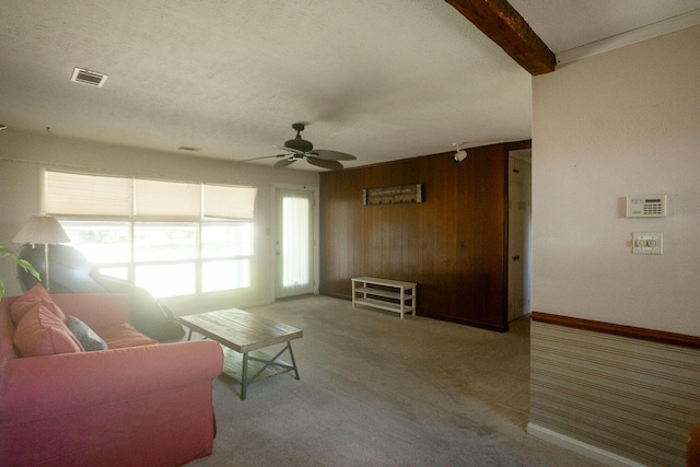 114 Bordeaux St, North Augusta, SC 29841 - carpeted living room with a ceiling fan, wooden walls, baseboards, and beamed ceiling