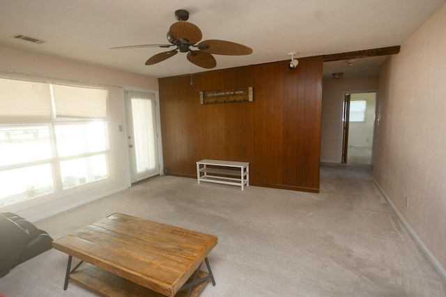 114 Bordeaux St, North Augusta, SC 29841 - living room with a ceiling fan, wood walls, light colored carpet, and baseboards