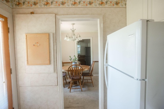 114 Bordeaux St, North Augusta, SC 29841 - kitchen with freestanding refrigerator, a chandelier, carpet, and crown molding