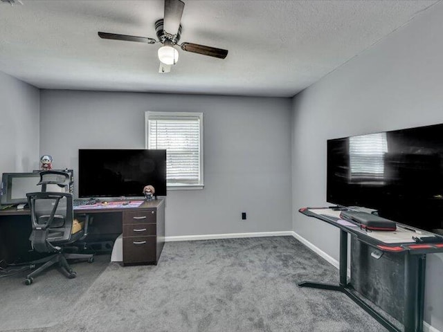 office area with a textured ceiling, baseboards, carpet floors, and ceiling fan