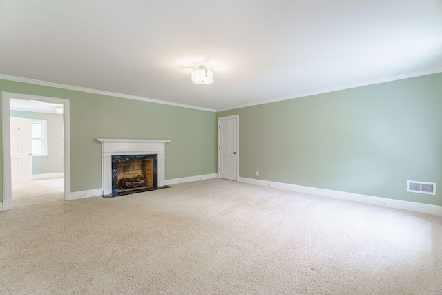 unfurnished living room with a premium fireplace, crown molding, and light colored carpet