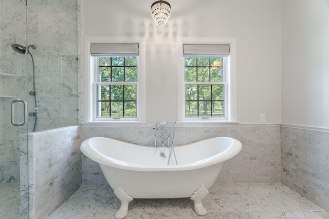 bathroom with plenty of natural light, plus walk in shower, and tile walls