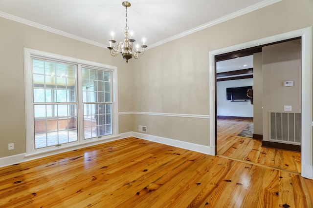 unfurnished dining area featuring crown molding, light hardwood / wood-style floors, and a notable chandelier