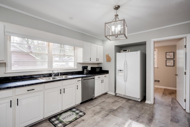 kitchen with white fridge with ice dispenser, stainless steel dishwasher, a sink, dark countertops, and ornamental molding