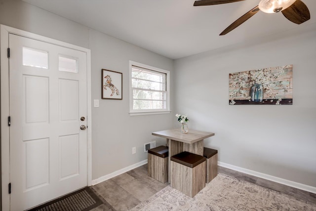 entryway with baseboards and ceiling fan