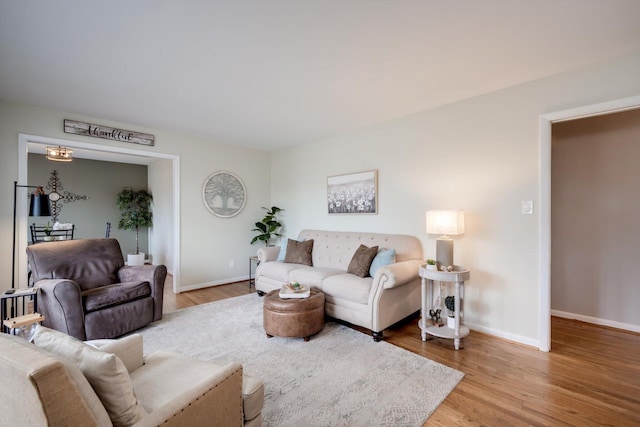 living room featuring wood finished floors and baseboards