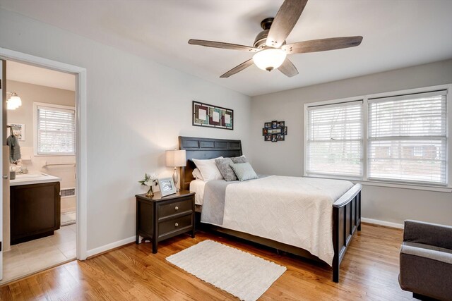 bedroom featuring baseboards, light wood-style floors, connected bathroom, and a ceiling fan