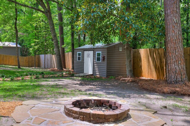 view of shed featuring an outdoor fire pit