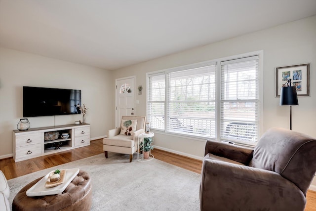 living area with wood finished floors and baseboards