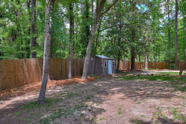 fenced backyard featuring a shed and an outdoor structure
