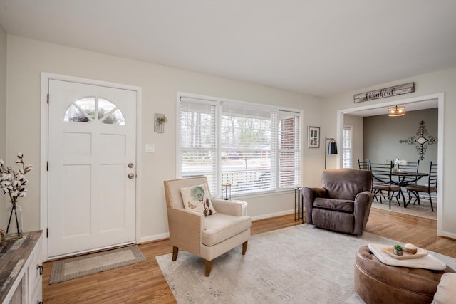 foyer entrance featuring light wood-style flooring and baseboards
