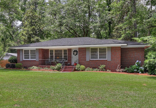 view of front of house featuring a porch, brick siding, and a front yard
