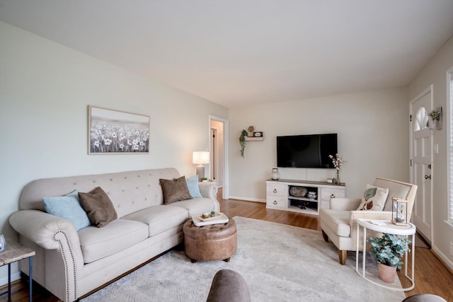 living area with wood finished floors and baseboards