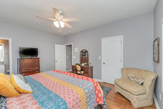 bedroom featuring baseboards, ceiling fan, and wood finished floors