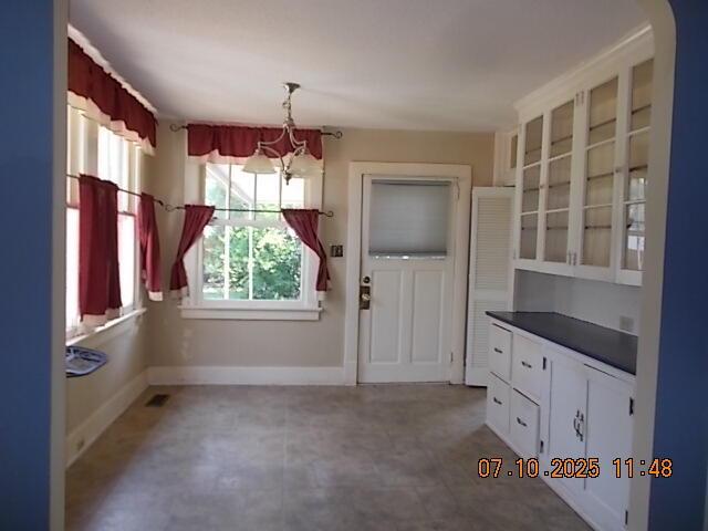 1420 Heath St, Augusta, GA 30904 - unfurnished dining area with a chandelier and arched walkways