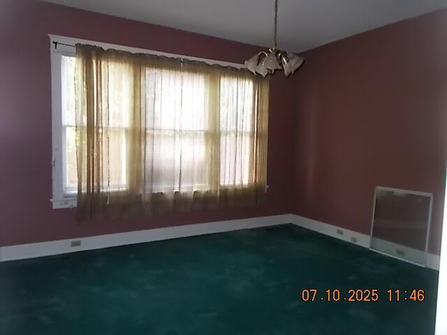 1420 Heath St, Augusta, GA 30904 - empty room with a chandelier and baseboards