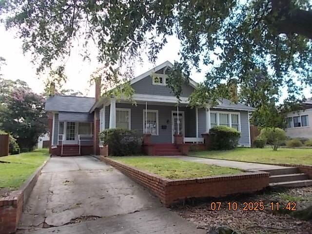 1420 Heath St, Augusta, GA 30904 - bungalow with a porch, a front lawn, driveway, and a chimney