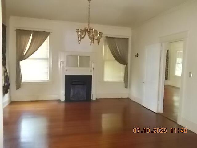 1420 Heath St, Augusta, GA 30904 - unfurnished living room with a chandelier, dark wood-style floors, and a fireplace