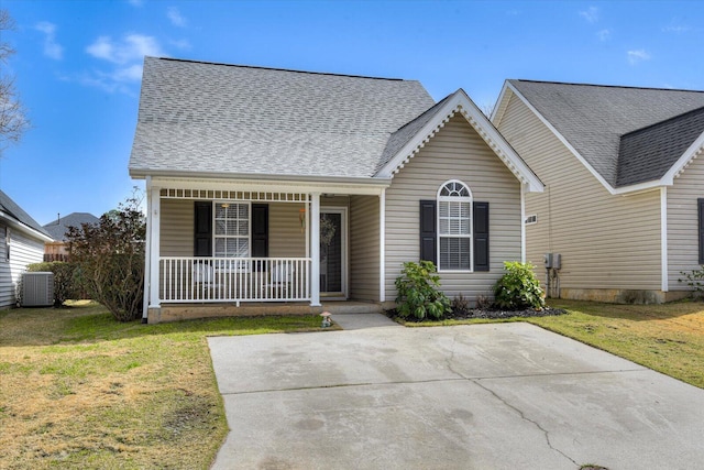 view of front of house featuring covered porch, roof with shingles, a front lawn, and central AC unit