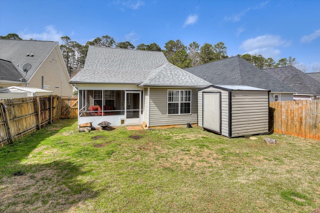 back of property featuring a storage shed, a fenced backyard, a sunroom, and a yard