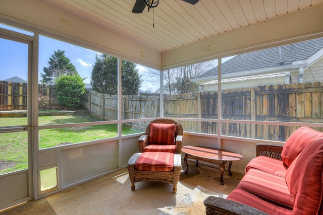 sunroom featuring wooden ceiling and a ceiling fan