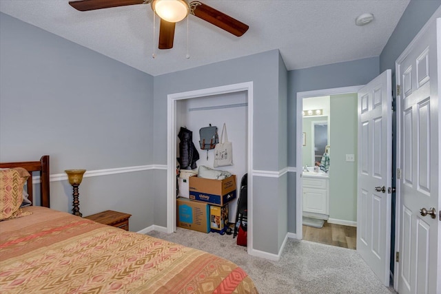 bedroom with ceiling fan, a closet, carpet flooring, and baseboards