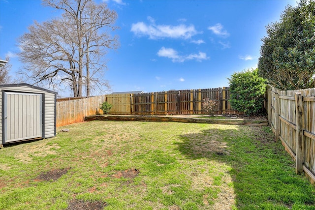 view of yard featuring a storage shed, a fenced backyard, and an outbuilding