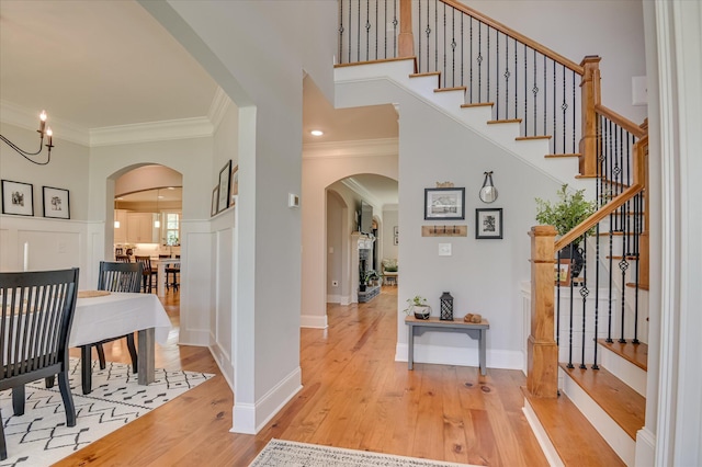 710 Nuttall St, Evans, GA 30809 - foyer featuring arched walkways, ornamental molding, light wood-style flooring, stairs, and a towering ceiling