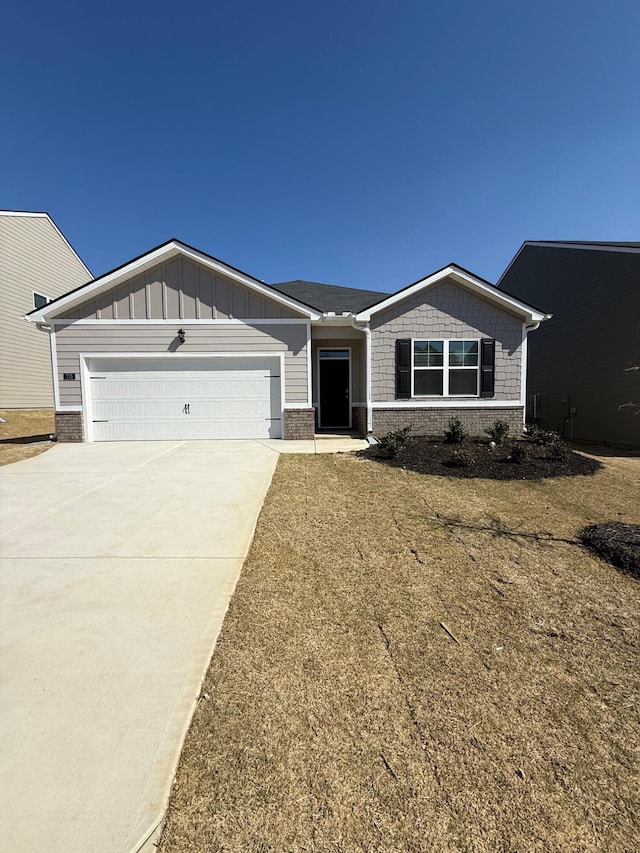 view of front of house featuring brick siding, driveway, a garage, and board and batten siding