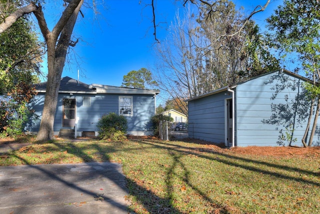 view of property exterior featuring a lawn