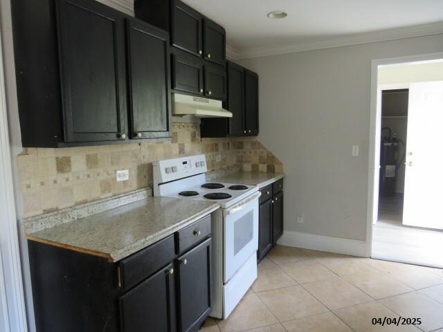 1937 Haynie Dr, Augusta, GA 30904 - kitchen with white electric range, light tile patterned floors, backsplash, and under cabinet range hood