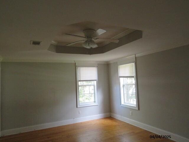1937 Haynie Dr, Augusta, GA 30904 - unfurnished room with visible vents, a raised ceiling, ornamental molding, a ceiling fan, and wood finished floors