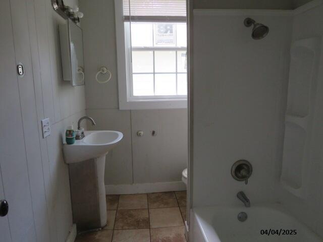 1937 Haynie Dr, Augusta, GA 30904 - bathroom featuring tub / shower combination, tile patterned flooring, toilet, a sink, and baseboards